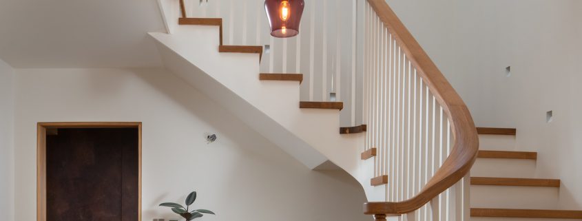 Entrance hall with a view of the stairs circling around the chandelier