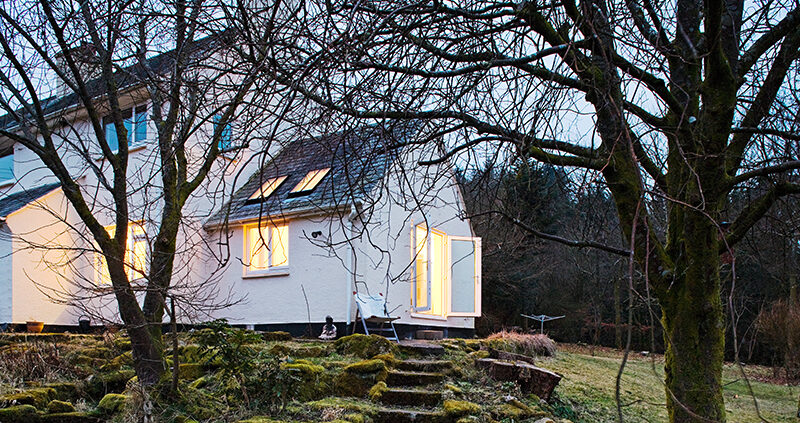 White cottage at night in dart more featuring old Dartmoor walls